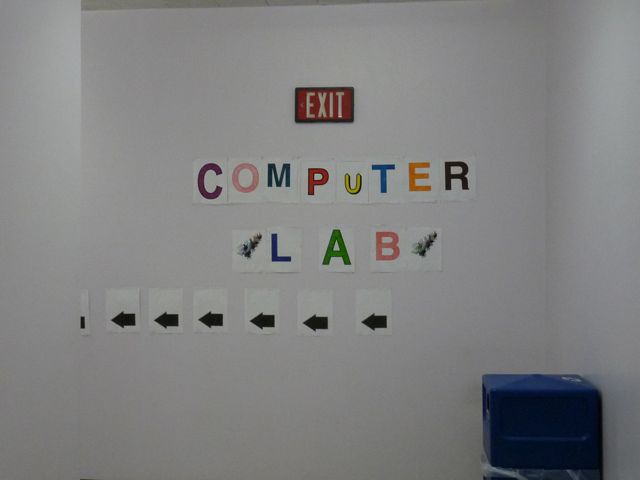 Here is an inexpensive sign indicating the place of a computer lab, hidden around a corner in the back of an auxiliary classroom building.