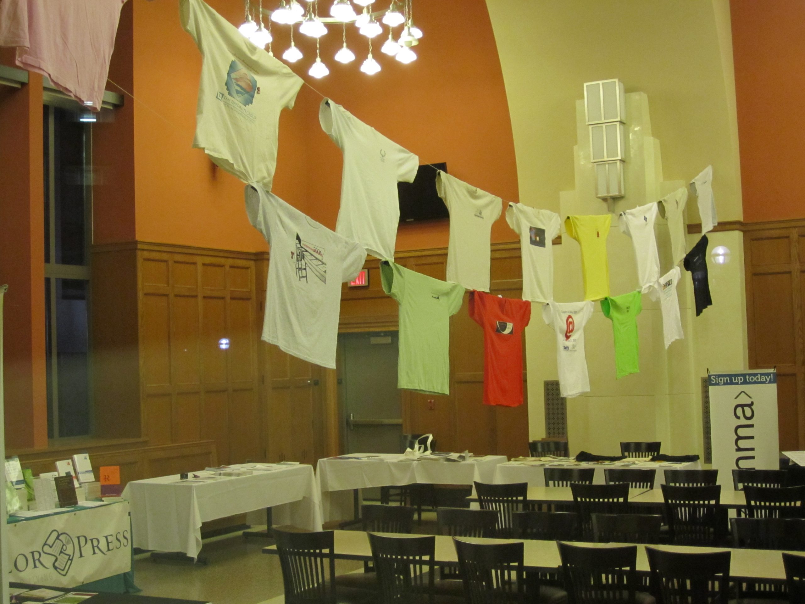 A picture of the main break area at CWC 2011, University of Michigan, including a professionally-hung display of the tee shirt collection