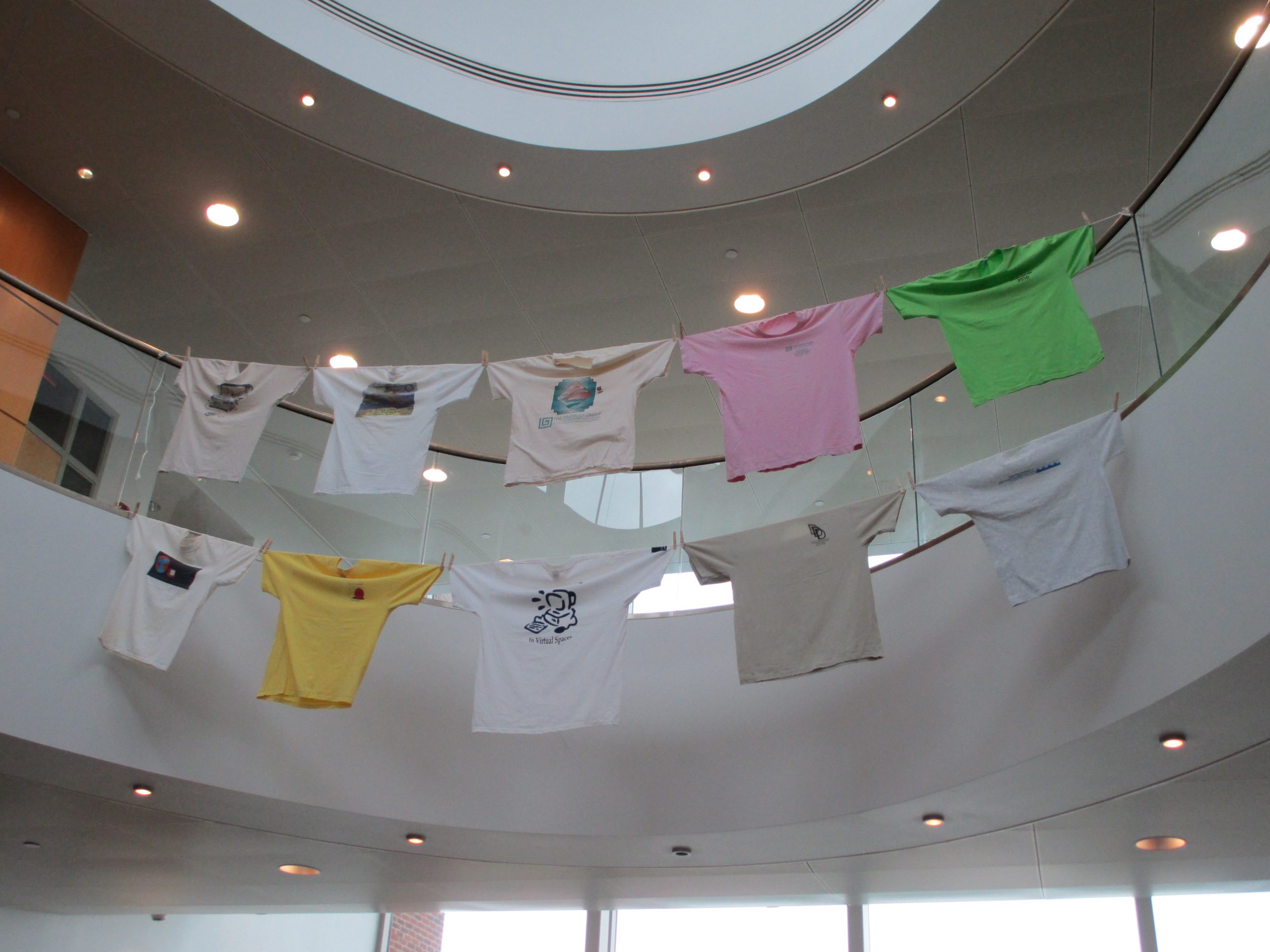 Tee shirts hung on clothslines across a rotunda area at the Computers and Writing 2013 registration area, Frostburg State Univesity, Maryland