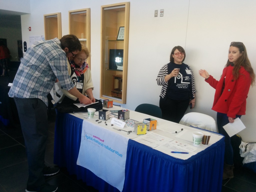 DRC Fellow Matt Vetter talks with Marcia Bost about the DRC Wiki Quest, while Fellows Paula Miller and Jenae Cohn prepare to hand out DRC Wiki Quest prize at Computers and Writing 2015