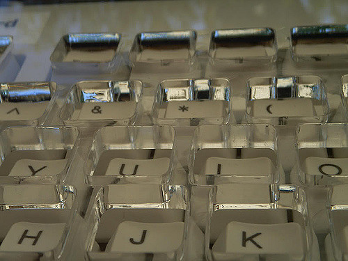 Close shot of keyboard with a clear plastic ergonomic stabilizer