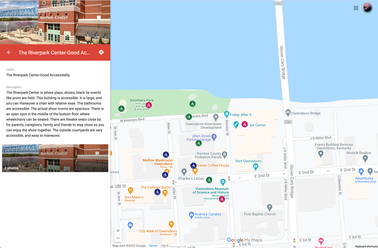 This map shows an area of a few square blocks in downtown Owensboro, Kentucky. It highlights several locations accessible by those using wheelchairs or other mobility devices. This screenshot highlights the RiverPark Center, a community space. The student’s description of this space says, “The Riverpark Center is where plays, shows, black tie events like prom are held. This building is accessible. It is large, and you can maneuver a chair with relative ease. The bathrooms are accessible. The actual show rooms are spacious. There is an open spot in the middle of the bottom floor where wheelchairs can be seated. There are theater seats close by for parents, caregivers, family and friends to stay close so you can enjoy the show together. The outside courtyards are very accessible, and easy to maneuver.”