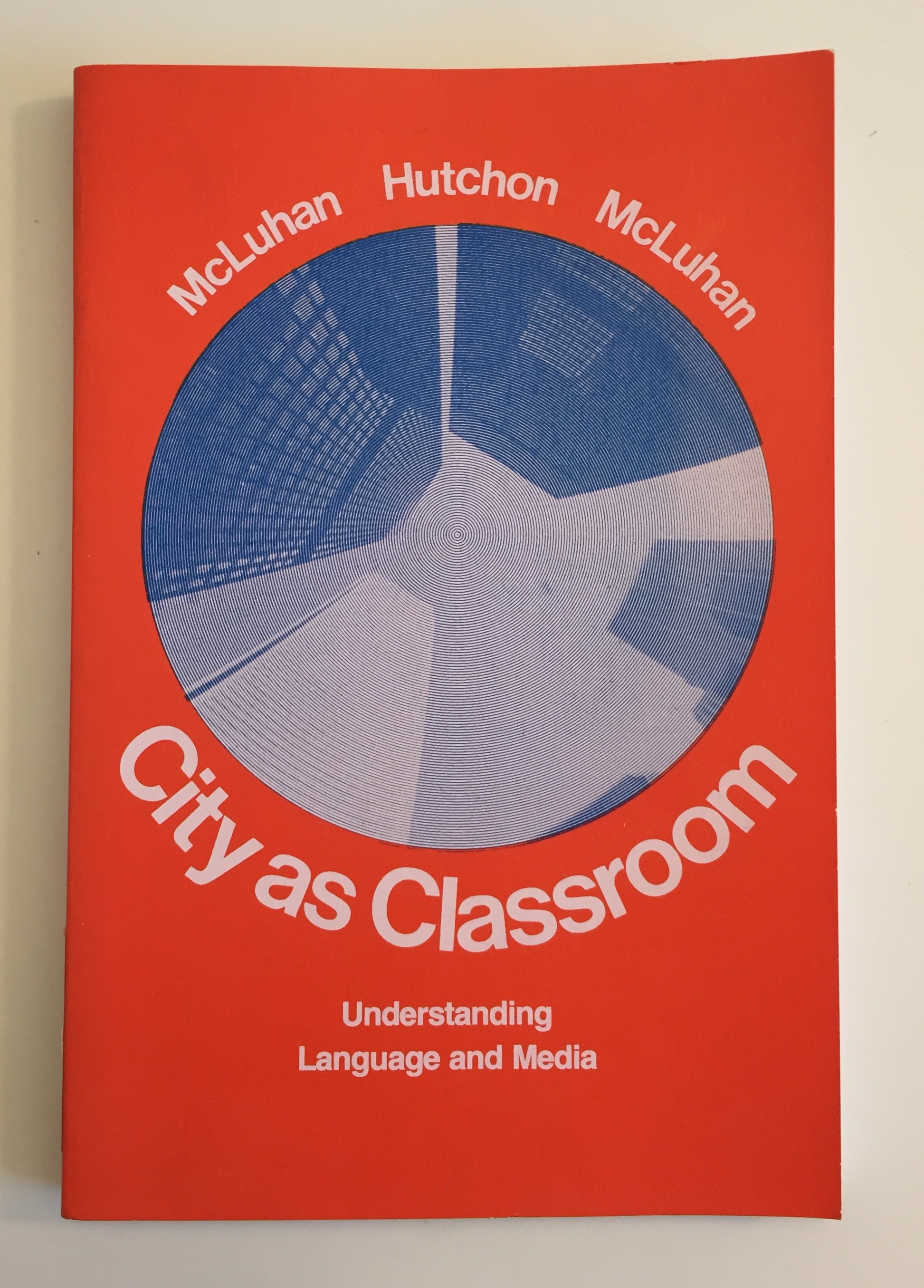 Cover of City as Classroom textbook, orange background with circular grey skyscraper image.
