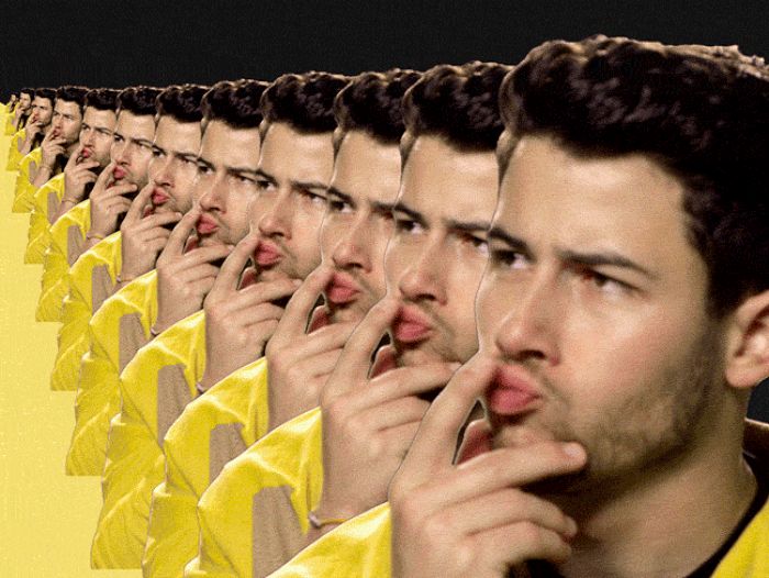 GIF of Nick Jonas thinking hard, his image reproduced in a seemingly infinite sequence; it truly is reflection all the way down.